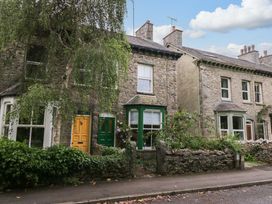A street view of stone houses with different colored doors at 28 Rock Villas in Carnforth