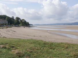 A beach with water and grass at 28 Rock Villas Carnforth