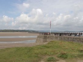 A pier with people sitting along it at 28 Rock Villas Carnforth