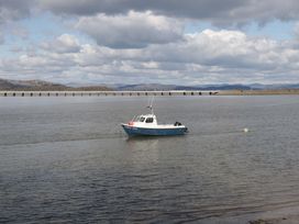 A boat in water with a pier in the background at 28 Rock Villas in Carnforth