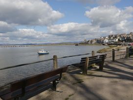 A view of a shoreline with a boat on water at 28 Rock Villas Carnforth