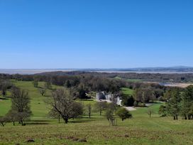 A scenic outdoor view of a building surrounded by trees and a river at 28 Rock Villas Silverdale