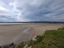 A landscape view of a beach with sand and water at 28 Rock Villas Silverdale