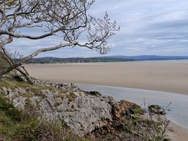 A coastal view with rocks and a tree at 28 Rock Villas Silverdale