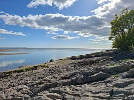 A scenic view of rocks and water under a cloudy sky at 28 Rock Villas Silverdale