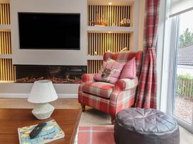 A living room with a television and sofa at Little Willesleigh in Goodleigh near Barnstaple