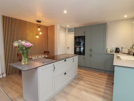 A kitchen with a kitchen island and oven at Little Willesleigh Goodleigh near Barnstaple