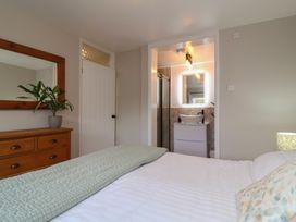 A bedroom with a bed and bathroom access at Little Willesleigh Goodleigh near Barnstaple