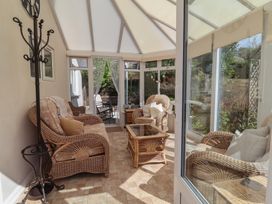 A conservatory with wicker furniture at Little Willesleigh Goodleigh near Barnstaple