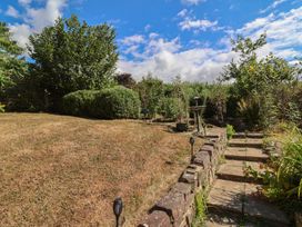 A garden with steps leading up to bushes and trees at Little Willesleigh Goodleigh near Barnstaple