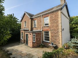 A brick house with a door and windows in an outdoor area at Gweryl Lodge in Conwy