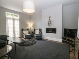 A living room with furniture and a television at Gweryl Lodge in Conwy