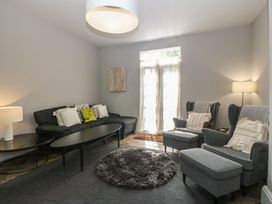 A living room with a sofa and armchairs at Gweryl Lodge in Conwy