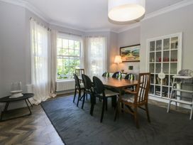 A dining room with a table and chairs at Gweryl Lodge in Conwy