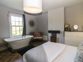 A bathroom with a bathtub and a window at Gweryl Lodge Conwy