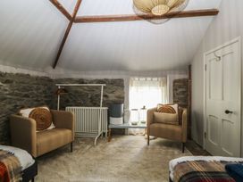 A sitting room with chairs and a table at Gweryl Lodge in Conwy