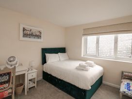 A bedroom with a bed, chair and fan at Full Deck in Dartmouth