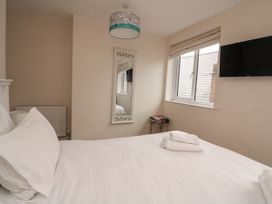 A bedroom with a bed and a television at Full Deck in Dartmouth