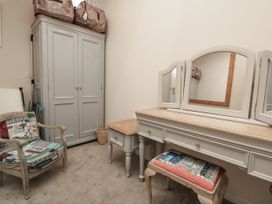 A dressing room with a wardrobe and dressing table at Full Deck in Dartmouth
