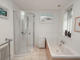 A bathroom with a shower and bathtub at Full Deck in Dartmouth
