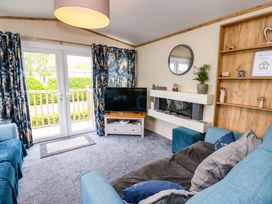 A living room with a television and sofa at Plot 41 High Hesket near Armathwaite