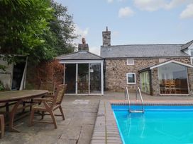 An outdoor area with a swimming pool and seating at Bryn Y Garreg - The Wireless Free Farm (No Tech!) Y Trallwng
