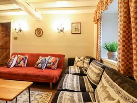 A living room with sofa and coffee table at Bryn Y Garreg - The Wireless Free Farm (No Tech!) Y Trallwng