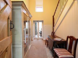 A hallway with a door and a cabinet at Bryn Y Garreg - The Wireless Free Farm (No Tech!) Y Trallwng