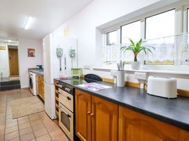 A kitchen with a refrigerator, oven, and countertop at Bryn Y Garreg - The Wireless Free Farm (No Tech!) in Y Trallwng