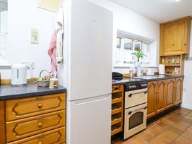 A kitchen with cabinets, a refrigerator, and a stove at Bryn Y Garreg - The Wireless Free Farm (No Tech!) Y Trallwng