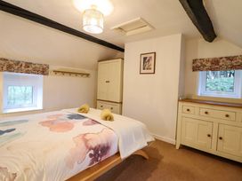 A bedroom with a bed and window at Bryn Y Garreg - The Wireless Free Farm (No Tech!) in Y Trallwng