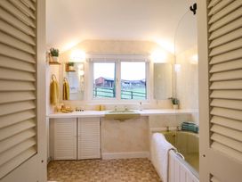 A bathroom with a sink, mirror, and shower at Bryn Y Garreg - The Wireless Free Farm (No Tech!) Y Trallwng