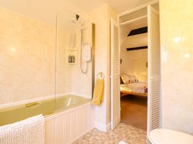 A bathroom with a bathtub and shower area at Bryn Y Garreg - The Wireless Free Farm (No Tech!) in Y Trallwng