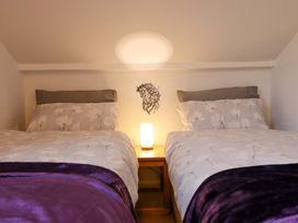 A bedroom with two beds and a lamp at Bryn Y Garreg - The Wireless Free Farm (No Tech!) Y Trallwng