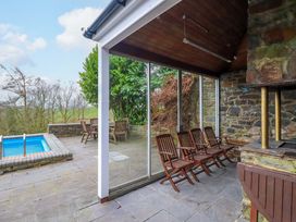 An outdoor space with a swimming pool and seating at Bryn Y Garreg - The Wireless Free Farm (No Tech!) Y Trallwng