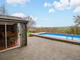An outdoor area with a swimming pool and dining setup at Bryn Y Garreg - The Wireless Free Farm (No Tech!) Y Trallwng