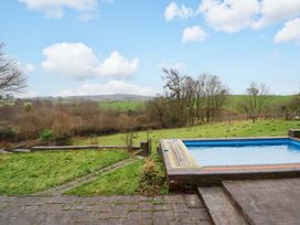 A garden with a swimming pool and grassy area at Bryn Y Garreg - The Wireless Free Farm (No Tech!) Y Trallwng