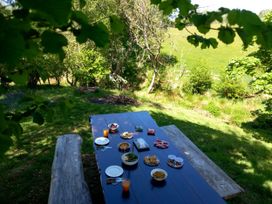 A table set with food and drinks in an outdoor area at Bryn Y Garreg - The Wireless Free Farm (No Tech!) Llangadfan near Llanwddyn