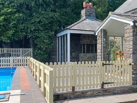 An outdoor area with a swimming pool and a fence at Bryn Y Garreg Cottage - The Wireless Free Farm, Llangadfan near Llanwddyn