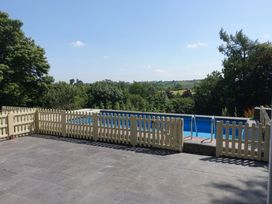 An outdoor area with a swimming pool and fence at Bryn Y Garreg Cottage - The Wireless Free Farm, Llangadfan near Llanwddyn