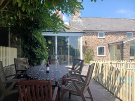 An outdoor dining area with a table and chairs at Bryn Y Garreg Cottage - The Wireless Free Farm near Llangadfan