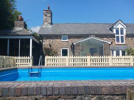A house with a swimming pool and fence at Bryn Y Garreg Cottage - The Wireless Free Farm in Llangadfan near Llanwddyn