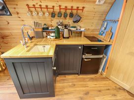 A kitchen corner with a sink a faucet a knife block and a small refrigerator at Hobhole in Keal Cotes near East Kirkby