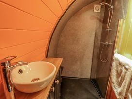 A bathroom with a round sink faucet and a walk-in shower with a towel hanging at Hobhole in Keal Cotes near East Kirkby