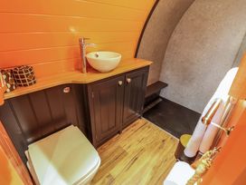 A bathroom with a toilet sink on wooden countertop and a walk in shower at Hobhole in Keal Cotes near East Kirkby
