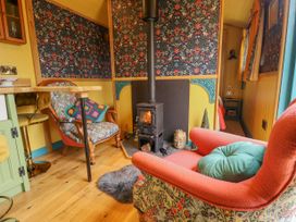 A small living area with two armchairs and a wood burning stove at Catchwater in Keal Cotes near East Kirkby