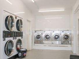 A laundry room with stacked dryers and front loading washing machines in 610 Caravan Bognor Regis