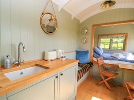 A kitchen area with a sink and toaster at Goose Whistle Hut in Foxham
