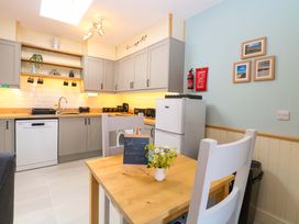 A kitchen with a table and chairs at Rainbow's End in Swanton Morley