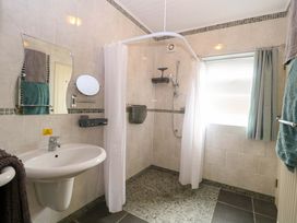 A bathroom with a shower and sink at Rainbow's End in Swanton Morley